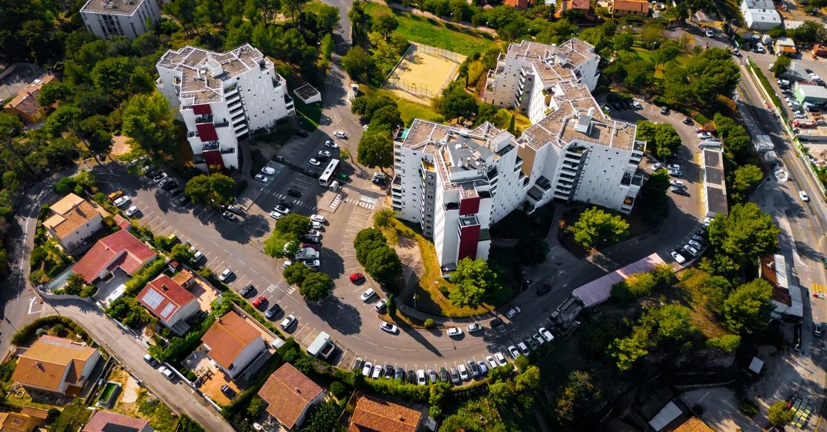 Vue aérienne d'un complexe résidentiel à Marseille, France, entouré d'une végétation luxuriante.